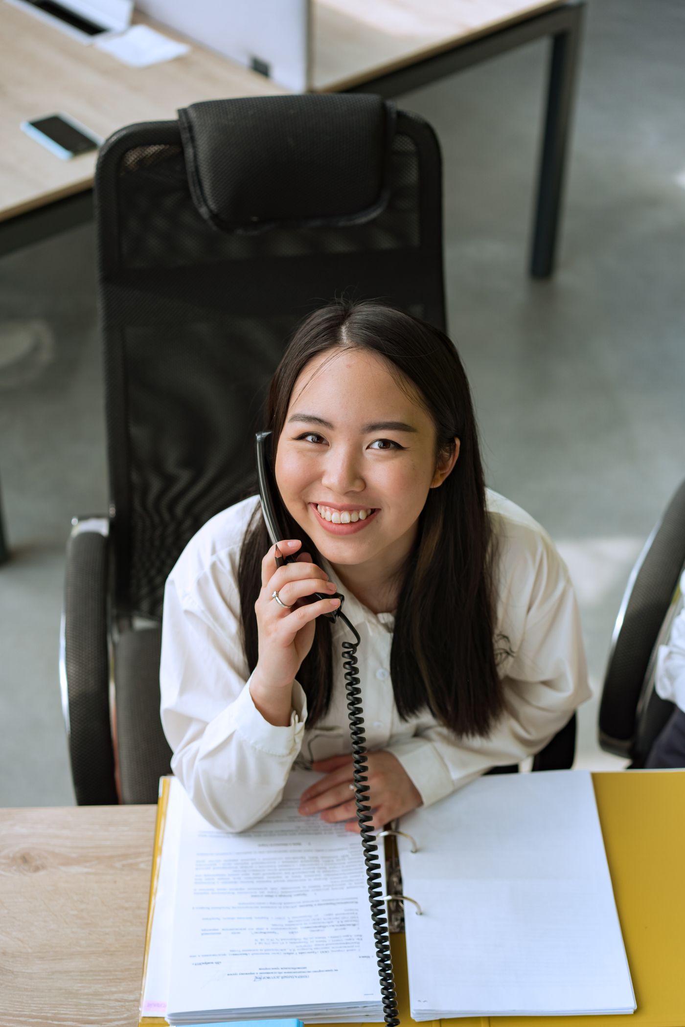 A friendly team member taking a phone call at the office