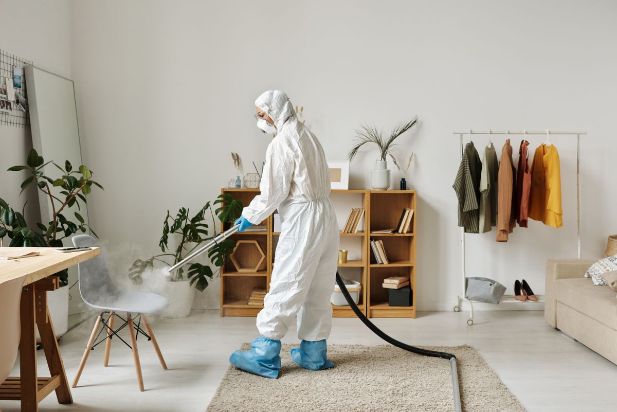 A specialist in protective equipment carrying out a professional deep clean and sanitisation
